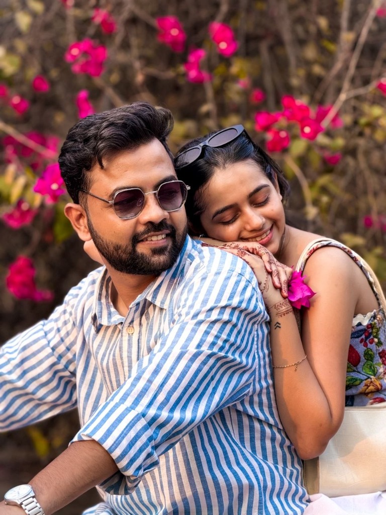 Akanksha leaning on Vikas with bougainvillea bloom